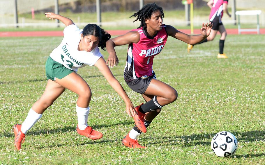 Kadena's NyKale Penn and Kubasaki's Lilyana Solano chase the ball during Wednesday's DODEA-Okinawa soccer match. The Panthers won 3-1.