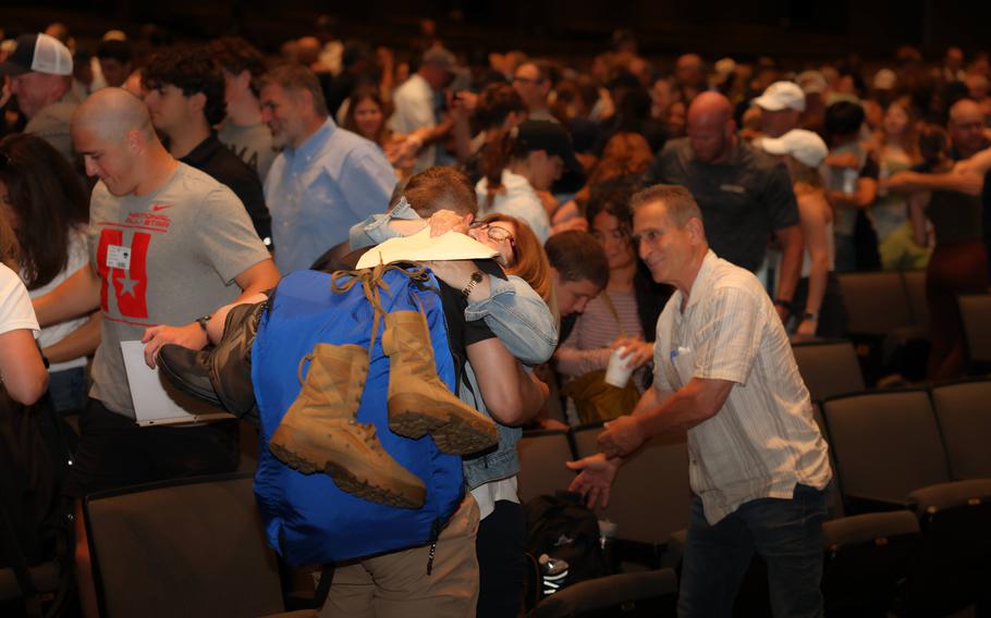 Cadets and their families in the auditorium.