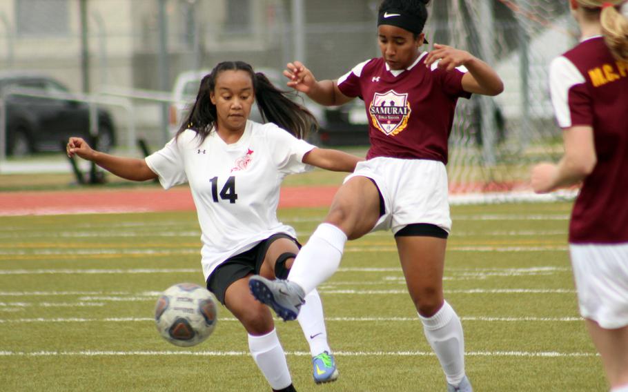 Matthew C. Perry's Ivanelis Nieves kicks the ball past E.J. King's Miu Best during Friday's DODEA-Japan soccer match. The Cobras won 2-1.