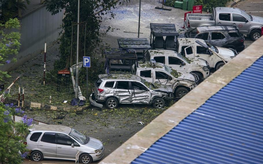 Destroyed and abandoned vehicles are seen at the scene of a blast in downtown Kampala, Uganda, Tuesday, Nov. 16, 2021. Two loud explosions rocked Uganda’s capital, Kampala, early Tuesday, sparking chaos and confusion as people fled what is widely believed to be coordinated attacks.