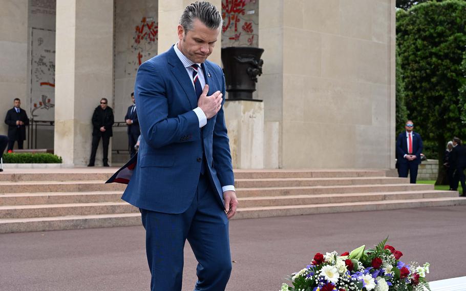 A man pays his respects at a cemetery.