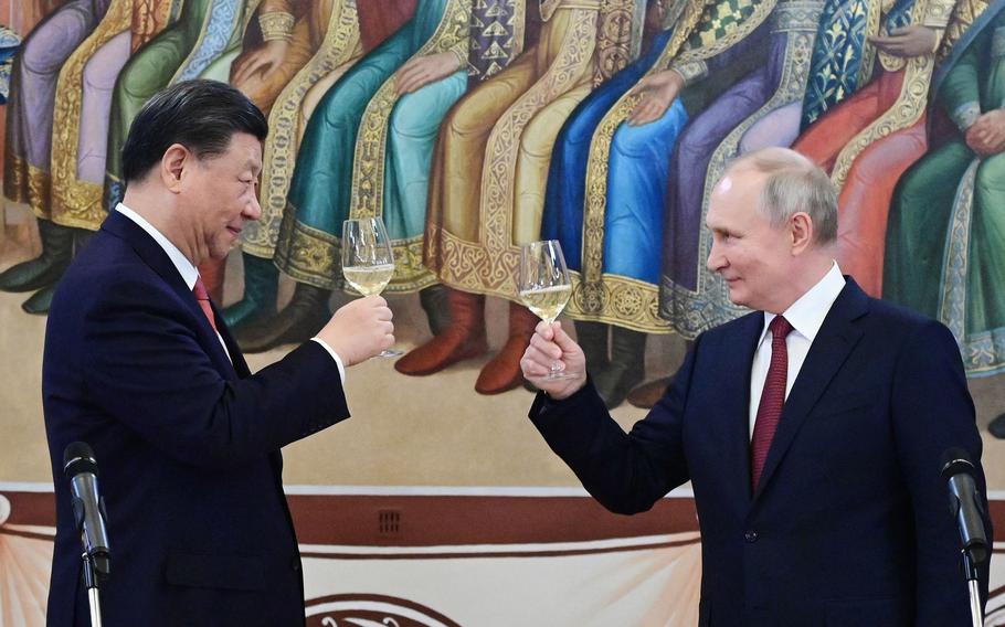 Russian President Vladimir Putin and China’s President Xi Jinping make a toast during a reception following their talks at the Kremlin in Moscow on March 21, 2023. 