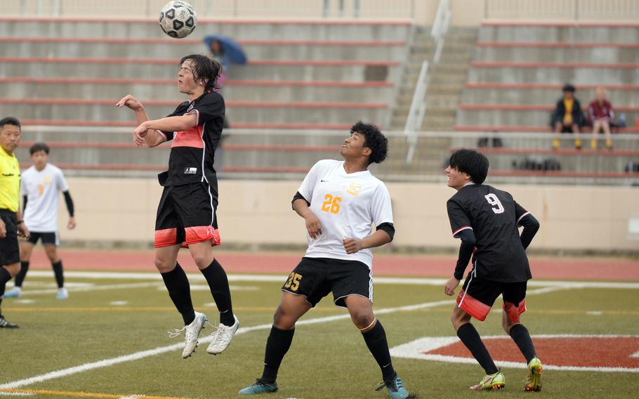 E.J. King's N.J. Reed heads the ball in front of Yokota's Jayden Royster and Cobras teammate Chris Garcia during Friday's DODEA-Japan boys soccer match. The teams battled to a scoreless draw.