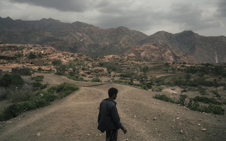 Mohammed Fulait Ahmed walks among the hills of his village, Moulis, in Yemen's Maghrabah district. 