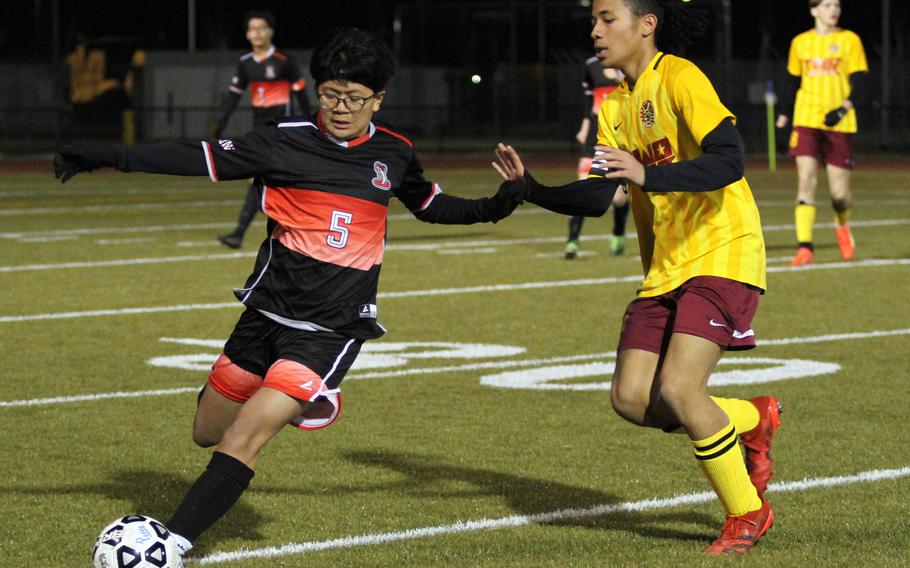 E.J. King's Jacob Ferrer dribbles against Matthew C. Perry's Dominic Williams during Friday's DODEA-Japan boys soccer season opener at Samurai Field. The Cobras won 3-2.