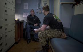 Navy Chaplain Lt. Cmdr. Ben Garrett counsels a sailor in his quarters on the USS Bataan on Monday, March 20, 2023 at Norfolk Naval Station in Norfolk, Va. 