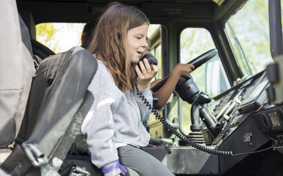 A youngster makes an announcement inside a P-19R Aircraft Rescue Fire Fighting vehicle assigned to Marine Wing Support Squadron 271 during a career fair in New Bern, N.C., on Friday, April 19, 2024. Marines from the 2nd Marine Aircraft Wing headquartered at Marine Corps Air Station Cherry Point, N.C., participated in the event at Oaks Road Academy to engage with the local community.
