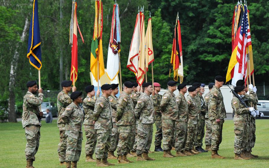 The color guard and soldiers of the 21st Theater Sustainment command stand on the Daener Kaserne parade ground during the unit’s change of command ceremony at Daenner Kaserne, Kaiserslautern, Germany, June 8, 2021. 