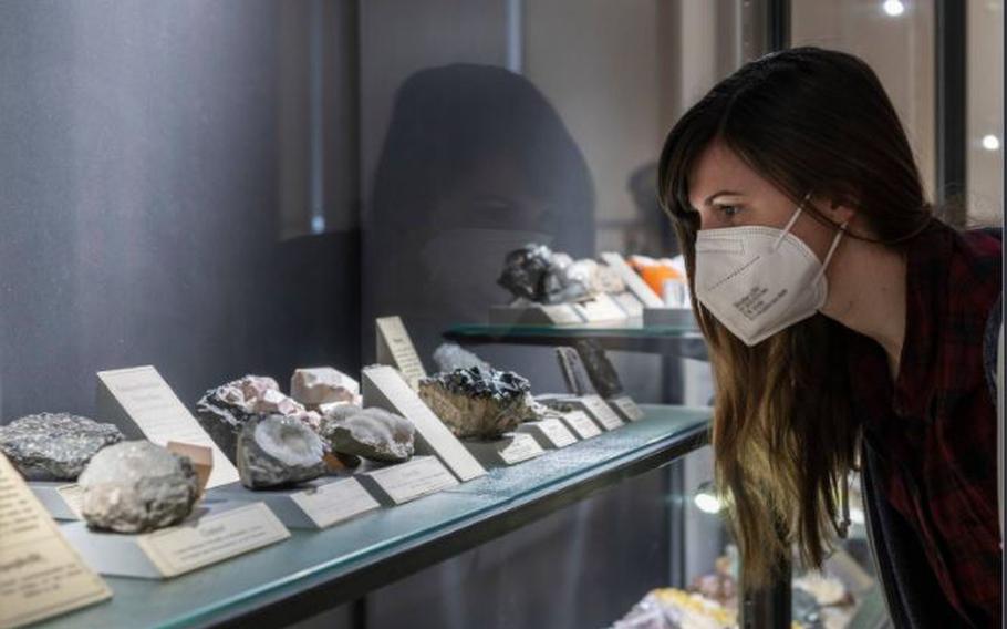 A visitor looks at a rock and crystal showcase at the “Fritz Geller-Grimm’s Crystals: From Diamonds to Gypsum” exhibition at Museum Wiesbaden in Wiesbaden, Germany. 