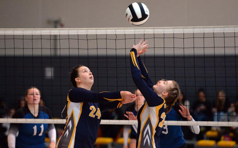 Ansbach’s Kennedy Lange, left, is on the ready as she watches teammate Natalie Ritter set the ball in the Division III final at the DODEA-Europe volleyball championships at Ramstein, Germany, Oct. 28, 2023. Ansbach beat Brussels 25-21, 17-25, 25-20, 25, 20 to take the title.