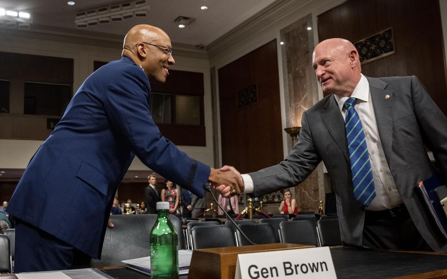 Gen. Charles Q. Brown Jr., left, shakes hands with Sen. Mark Kelly (D-Ariz.) before a hearing to confirm Brown as chairman of the Joint Chiefs of Staff on July 11, 2023. 