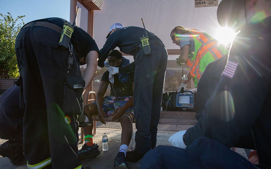 Firefighters in Phoenix provide treatment for a resident having trouble breathing on day when temperatures reached 119F. The city has endured a record-setting streak of days above 110F this month. 