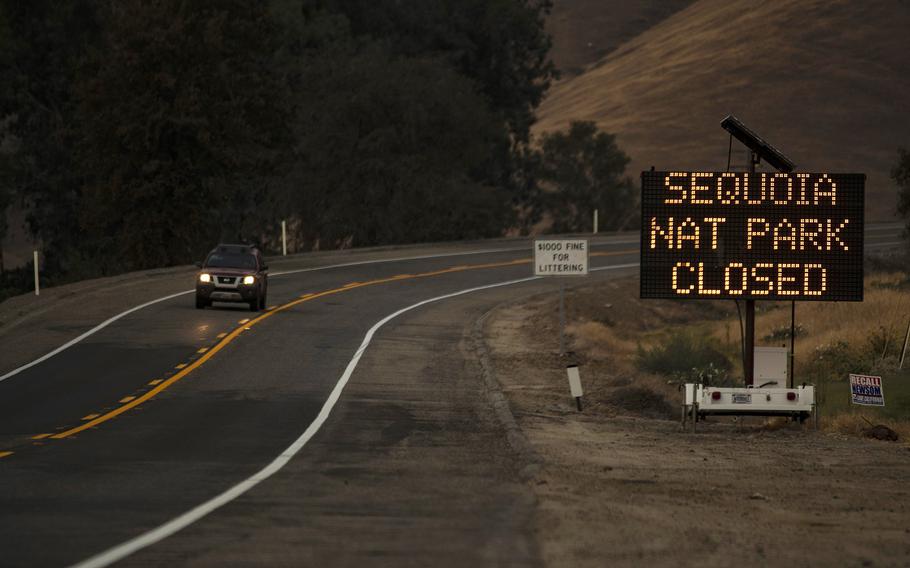 A sign warns motorists of the closure of Sequoia National Park as the KNP Complex fire threatens the area on Sept. 15, 2021 in Three Rivers, Calif.