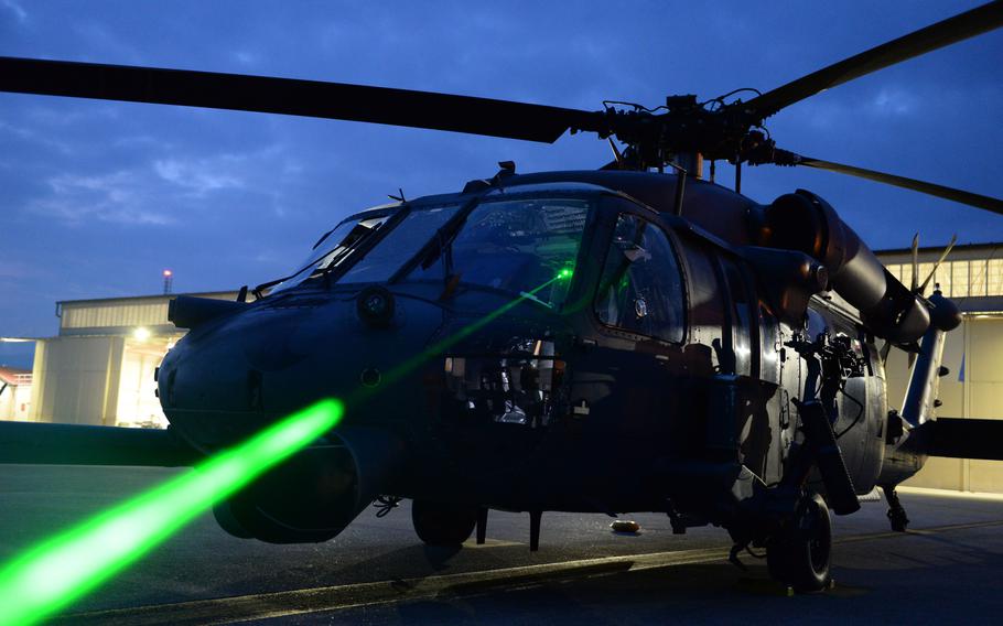 U.S. Air Force Master Sgt. Miguel Gibson, 31st Fighter Wing flight safety manager, demonstrates how pointing a laser at an HH-60 Pave Hawk can illuminate the cockpit at Aviano Air Base, Italy, Oct. 12, 2023. 