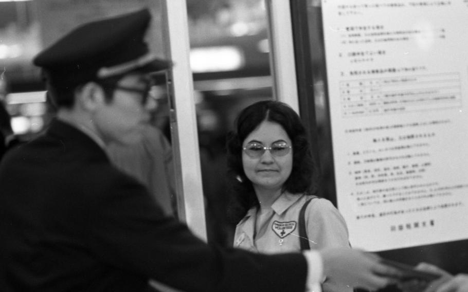 A woman is being assisted after a flight