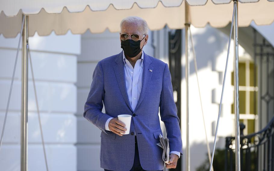 President Joe Biden walks over to speak with members of the press before boarding Marine One on the South Lawn of the White House, Saturday, Oct. 2, 2021, in Washington. Biden is spending the weekend at his home in Delaware.