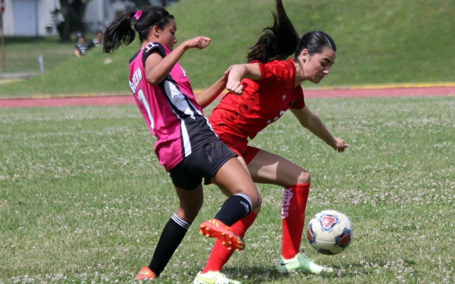 Kadena's Mia Garza and Nile C. Kinnick's Julia Angelinas scrum for the ball during Monday's Division I girls soccer tournament match. The Panthers handed the Red Devils their first loss of the season 4-1.