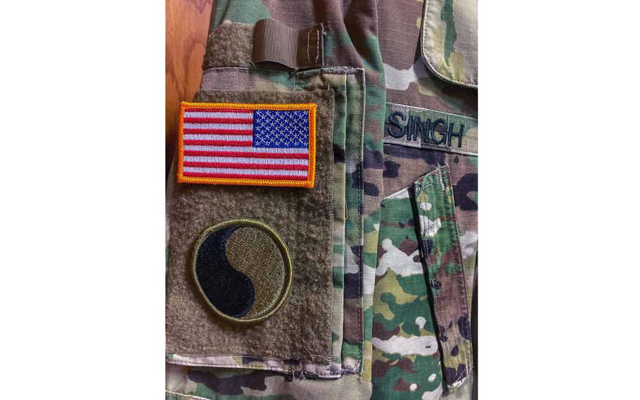 A uniform once worn by Maj. Gen. Linda L. Singh on display May 25, 2022, in the modern-era section of the Maryland Museum of Military History in Baltimore. It bears an Army green-and-black version of the insignia of the 29th Infantry Division’s yin yang-style patch. The original blue-and-gray version was designed to signify unity among soldiers from states with ties to the United States of America and the Confederate States of America.