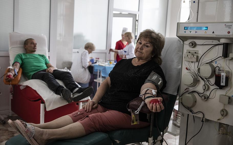 Svitlana Mymokhod, 58, an accountant who began cooking for local army units, donates blood in Mykolaiv, Ukraine, on Sept. 3, 2022.