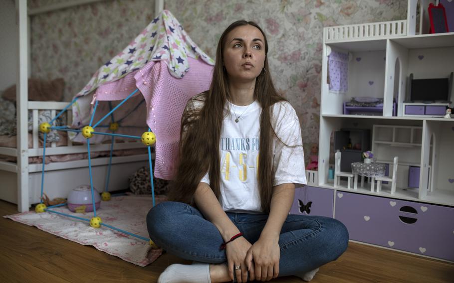 Yuliia Sirenko sits in her daughter's bedroom on Aug. 11, 2022.