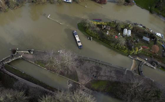 FILE - A narrow boat sits in the floods of the river Thames in Oxford, England, Sunday, Jan. 7, 2024. Britain was hit by heavy rainfall last week following storm Henk, which led to flooding in parts of the UK. Europe is the fastest-warming continent and its temperatures are rising at roughly twice the global average, two top climate monitoring organizations reported Monday, April 22, 2024, warning of the consequences for human health, glacier melt and economic activity. (AP Photo/Frank Augstein, File)