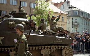 World War II reenactors wave from a tank to crowds during the parade May 4, 2025, at the Pilsen Liberation Festival in Pilsen, Czech Republic, commemorating the 80th anniversary of the city's World War II liberation.
