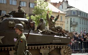 World War II reenactors wave from a tank to crowds during the parade May 4, 2025, at the Pilsen Liberation Festival in Pilsen, Czech Republic, commemorating the 80th anniversary of the city's World War II liberation.