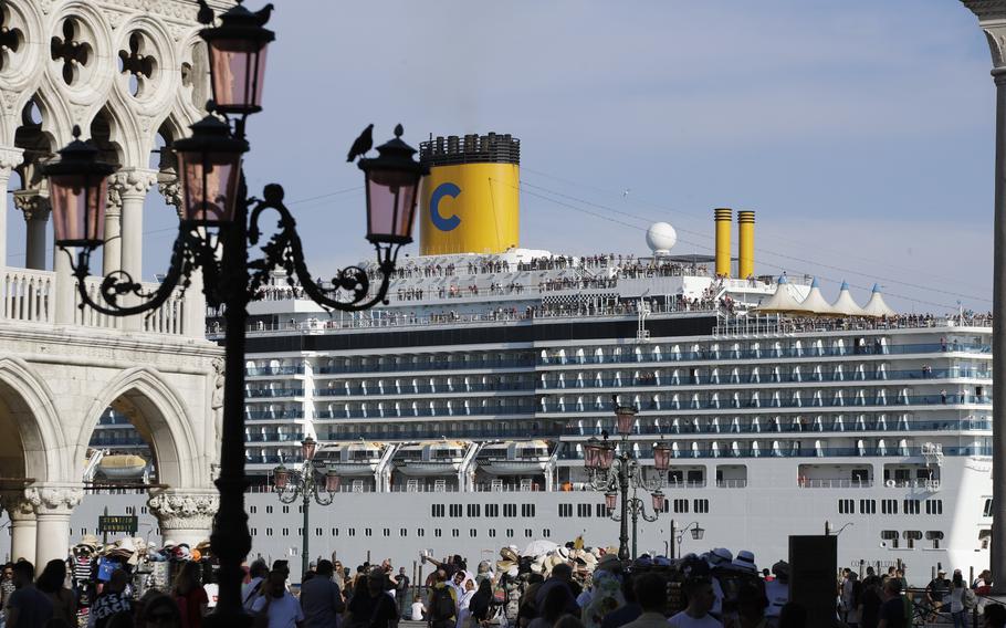 A cruise ship passes by St. Mark's Square filled with tourists June 2, 2019 in Venice, Italy. Declaring Venice's waterways a “national monument,” Italy is banning mammoth cruise liners from sailing into the lagoon city, which risked within days being declared an imperiled world heritage site by the United Nations. Culture Minister Dario Franceschini said the ban will take effect on Aug. 1 and was urgently adopted at a Cabinet meeting on Tuesday.