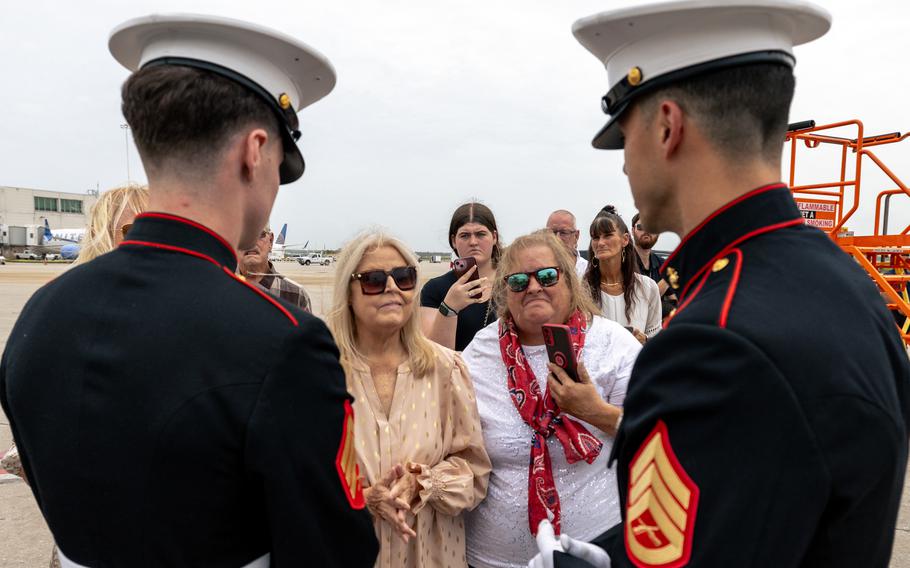 Two Marines speak with the family. 