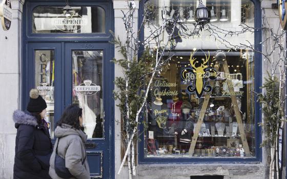 Shoppers stroll through the Old Montreal neighborhood of Montreal, Quebec, on April 7, 2023. 