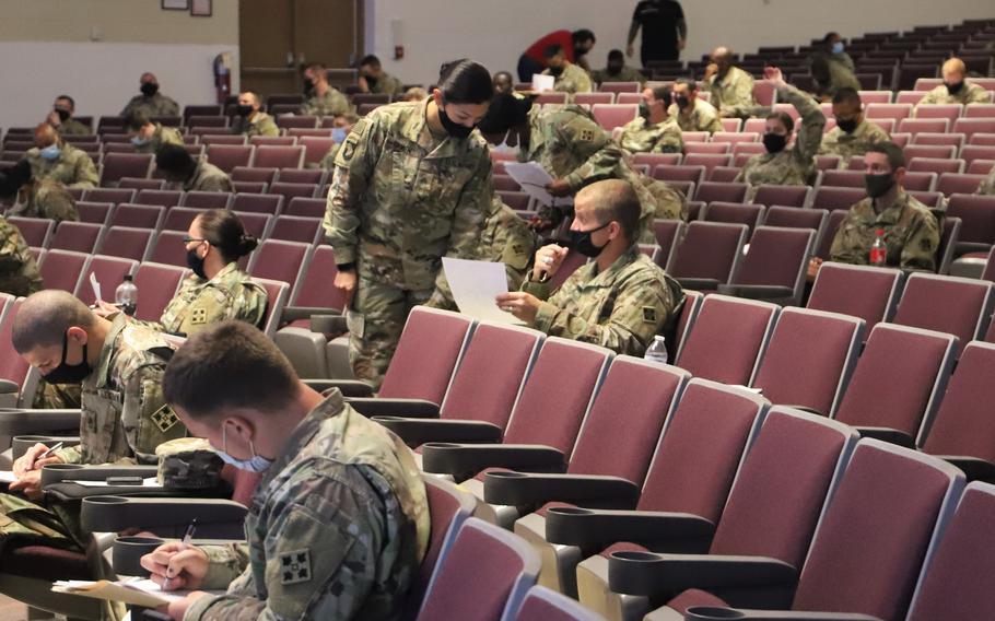 In-processing soldiers fill out their travel vouchers during a finance brief at Fort Carson, Colo., Aug. 21, 2020. 