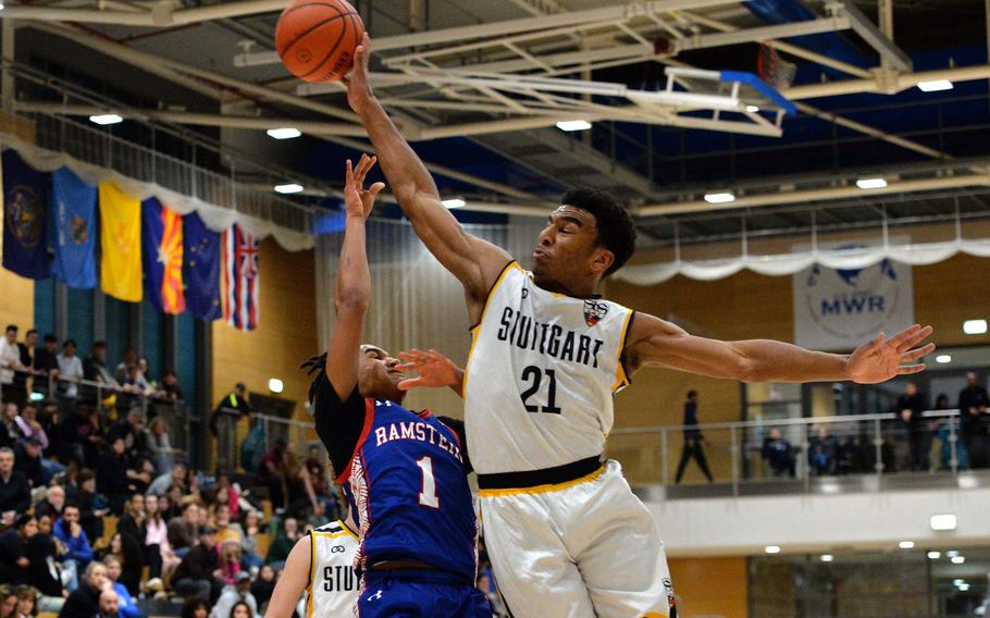 Stuttgart’s Alex Guthrie blocks a shot by Ramstein’s Christian Roy in the boys Division I final at the DODEA-Europe basketball championships in Wiesbaden, Germany, Feb. 17, 2024. The Panthers beat the Royals 47-36 to take the DI title.