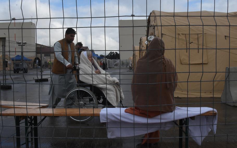 A woman in a wheelchair inside temporary living facilities for evacuees from Afghanistan said Monday, Aug. 23, 2021, that she was an American citizen waiting for transit back to the United States.