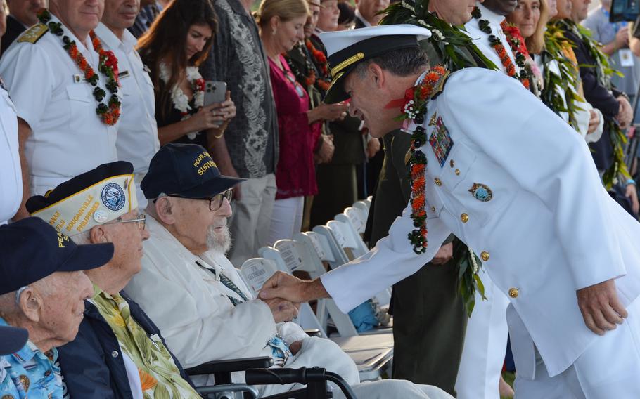 Adm. John Aquilino, commander of U.S. Indo-Pacific Command, greets Ira Schab, a 103-year-old survivor of Japan's surprise attack on Oahu, during a ceremony at Pearl Harbor National Memorial, Hawaii, Dec. 7, 2023.