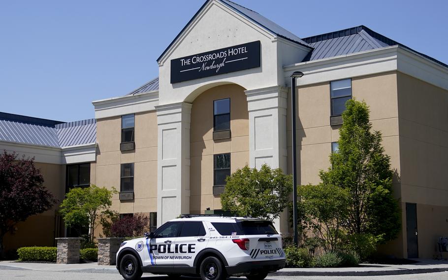 A Town of Newburgh police vehicle sits parked outside The Crossroads Hotel, where two busloads of migrants arrived hours earlier, on May 11, 2023, in Newburgh, N.Y. The founder of a nonprofit group has been accused of fabricating a story about homeless military veterans being evicted from the hotel to make room for international migrants, a tale that stoked days of outrage on cable news networks.