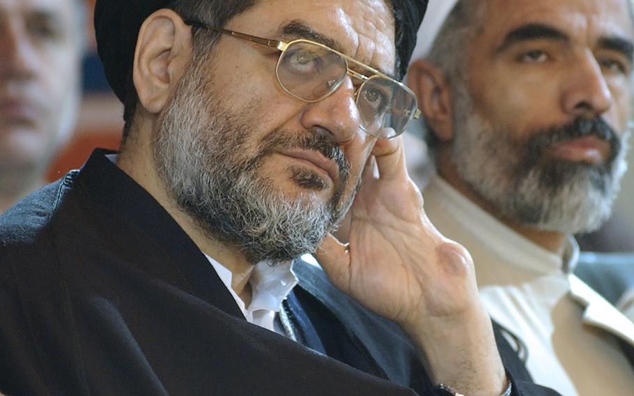 Ali Akbar Mohtashamipour attends a meeting in Tehran, Iran, on Dec. 4, 2003. Mohtashamipour, a Shiite cleric who as Iran's ambassador to Syria helped found the Lebanese militant group Hezbollah and lost his right hand to a book bombing reportedly carried out by Israel, died Monday, June 7, 2021, of the coronavirus.