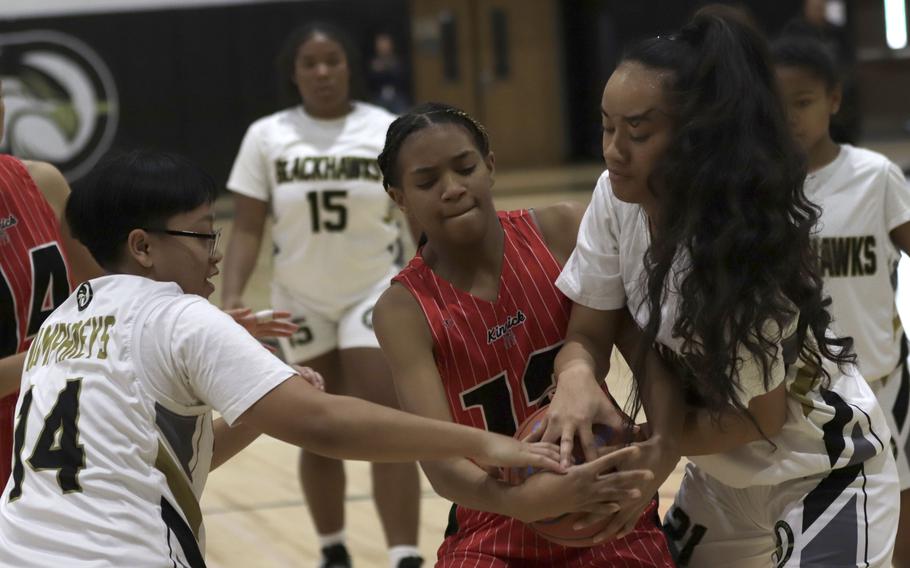 Humphreys' Stephanie Gabriel and Vaitupua Maina and Nile C. Kinnick's Imani Mincey scuffle for the ball during Monday's Far East Girls Division I round-robin game, won by the Blackhawks 40-33.