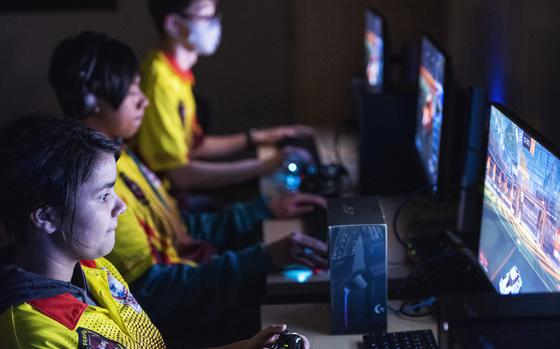 Trinity Downing, front, Jaiden Desilba, center, and Erin Eliason practice Rocket League for the varsity esports team at Matthew C. Perry High School on Marine Corps Air Station Iwakuni, Japan, Nov. 23, 2022.