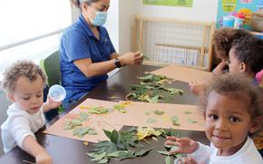 Isela Orona, a child care provider at Fort Carson, Colo., leads children in a fall learning activity in 2021. Workers and participants in the Army’s child and youth services programs will no longer be required to receive the COVID-19 vaccine, the service said in a memo Aug. 25, 2025.