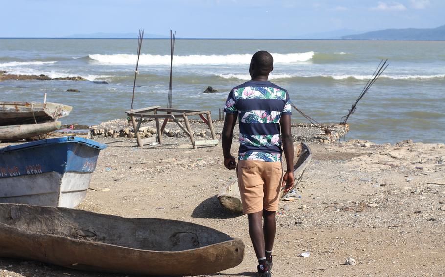 Jeff Pierre walks toward the sea Nov. 16 near where he lives in Jérémie, Haiti. He has already tried once to leave the country by boat and reach the United States because, he says, “This country does not offer me anything.” 