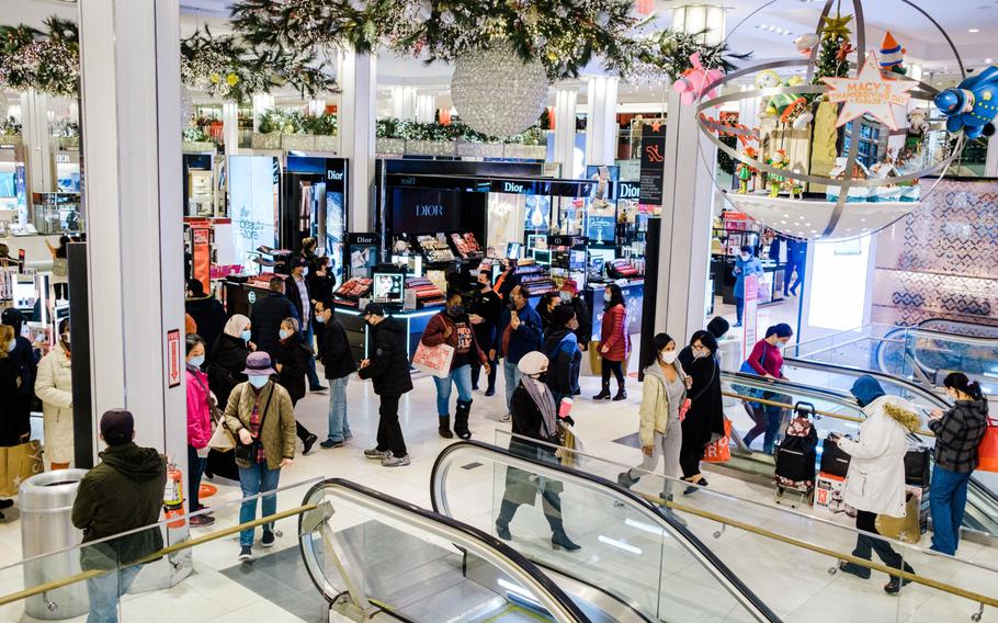 Shoppers walk through Macy’s flagship store in the Herald Square area of New York on Nov. 27, 2020. 