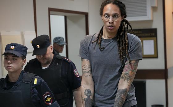 FILE - WNBA star and two-time Olympic gold medalist Brittney Griner is escorted from a courtroom after a hearing in Khimki just outside Moscow, on Aug. 4, 2022. Russia has freed WNBA star Brittney Griner on Thursday in a dramatic high-level prisoner exchange, with the U.S. releasing notorious Russian arms dealer Viktor Bout. (AP Photo/Alexander Zemlianichenko, File)