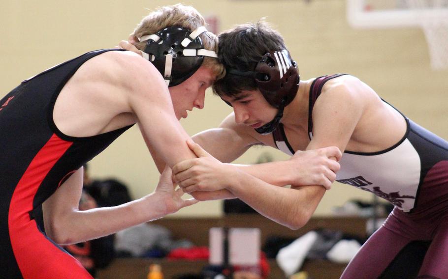 Nile C. Kinnick's Logan Hamilton and Matthew C. Perry's Trevor Hughes face off at 115 pounds during Saturday's DODEA-Japan wrestling dual meet. Hamilton won by technical fall and the Red Devils won the dual meet 39-22.