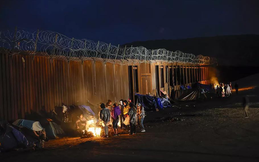 Asylum seekers from China, Colombia and the Middle East camp near the border wall in Jacumba, California. 