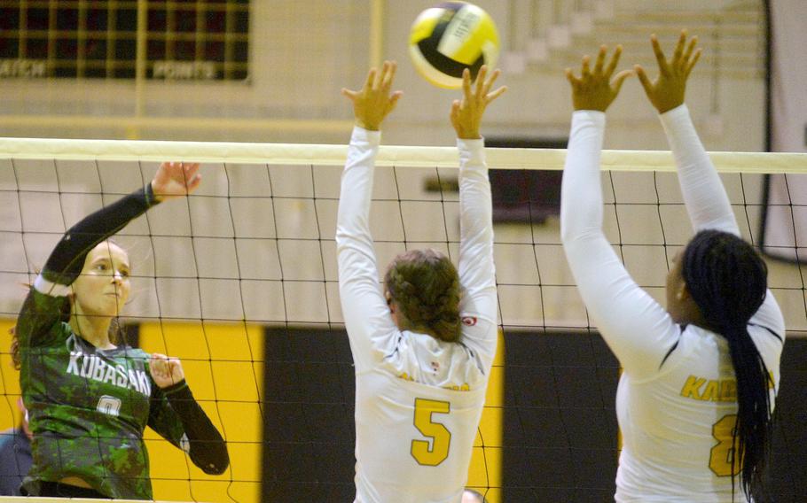 Kubasaki's Alice Baron spikes through the double block of Kadena's Morgan Sayers and Kyleigh Wright during Tuesday's Okinawa volleyball match. The Dragons beat the Panthers in straight sets for the fifth time this season.