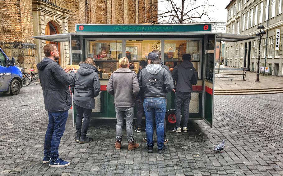 An award-winning hot dog stand in Copenhagen, DOP - or Den Okologiske Polsemand - attracts a line. 