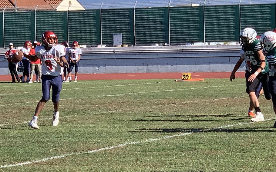 Aviano's Andrew Walker looks for a receiver during Saturday's DODEA European Division II championship game. Naples went on to win 47-6.