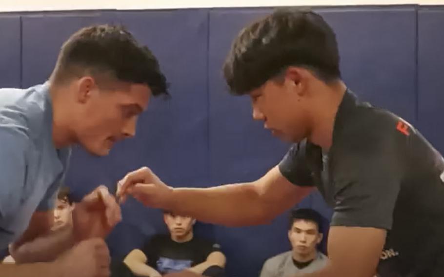 A video screen grab shows Bashir Rostami, right, during wrestling practice.