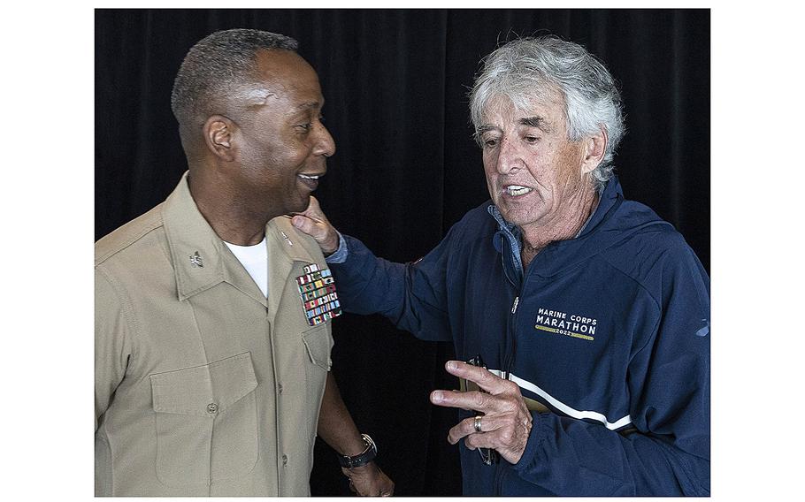 Olympic marathon champion Frank Shorter talks with Col. Michael Brooks, Marine Corps Base Quantico commanding officer, after Friday's Marine Corps Marathon press conference in Arlington, Va.