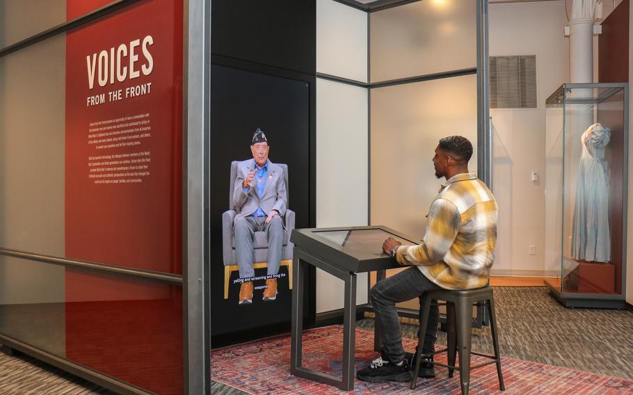 Devin Dumas speaks with a video image of the late World War II veteran Hershel “Woody” Williams as part of the new Voices From the Front exhibit at the National WWII Museum in New Orleans. 